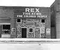 This building bears the name “Rex Theatre for Colored People,” showing the racial segregation of cinemas in Leland, Mississippi (U.S.). June 1937.