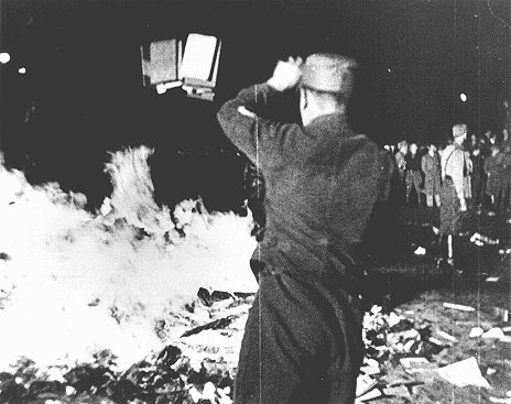At Berlin's Opernplatz, an SA man throws books into the flames at the public burning of books deemed "un-German." Berlin, Germany, May 10, 1933.