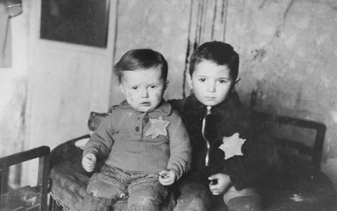 Two young brothers, seated for a family photograph in the Kovno ghetto. One month later, they were deported to the Majdanek camp. Kovno, Lithuania, February 1944.