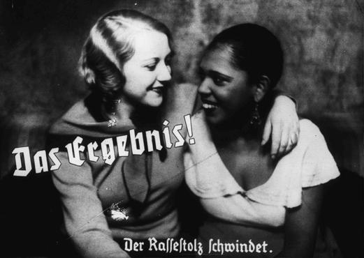 Nazi propaganda photo depicts friendship between an "Aryan" and a black woman. The caption states: "The result! A loss of racial pride." Germany, prewar.