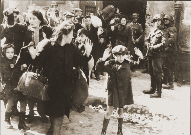Jews captured by German troops during the Warsaw Ghetto uprising in April-May 1943.  This photograph appeared in the Stroop Report, an album compiled by SS Major General Juergen Stroop, commander of German forces that suppressed the Warsaw ghetto uprising.  The album was introduced as evidence at the International Military Tribunal at Nuremberg.  In the decades since the trial this photo has become one of the iconographic images of the Holocaust.