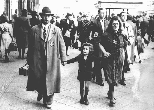 Members of a Jewish family walking along a Berlin street wear the compulsory Star of David. Berlin, Germany, September 27, 1941.