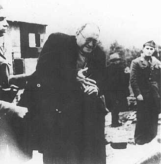 Ustasa (Croatian fascist) camp guards order a Jewish man to remove his ring before being shot. Jasenovac concentration camp, Yugoslavia, between 1941 and 1945.