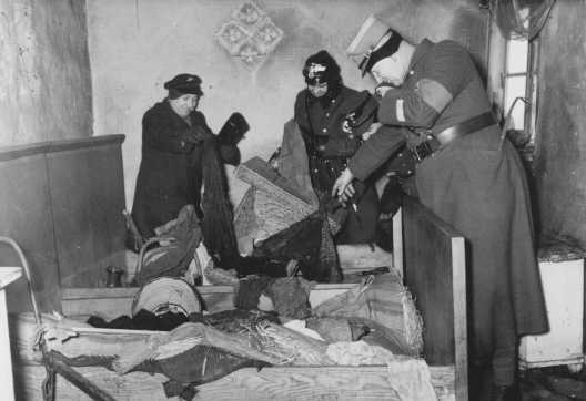 German police raid a vandalized Jewish home in the Lodz ghetto. Lodz, Poland, ca. 1942.