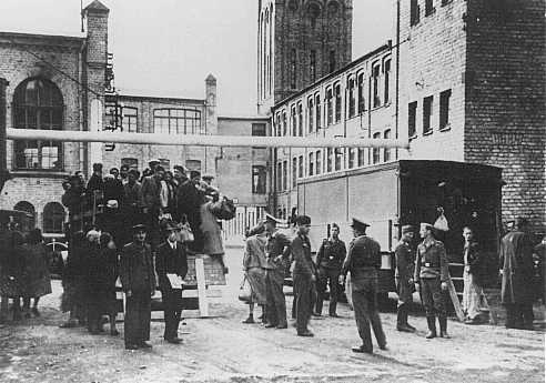 Jews from the Riga ghetto arrive at their forced-labor assignment in the Luftwaffe (German air force) field clothing depot. Riga, Latvia, 1942.