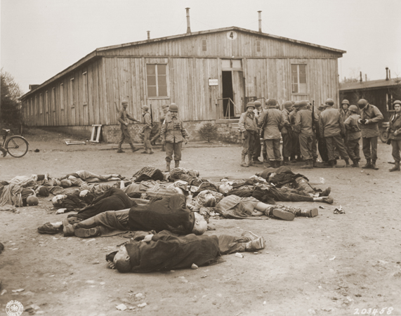 American soldiers view the bodies of prisoners found in the newly liberated Ohrdruf concentration camp. Ohrdruf, Germany, April 6, 1945.