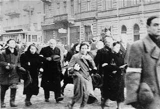 Jews from the Warsaw ghetto are marched through the ghetto during deportation. Warsaw, Poland, 1942-1943.
