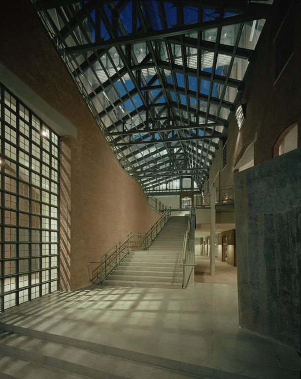 Interior of the United States Holocaust Memorial Museum with the early morning sky through the roof's windows