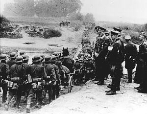 Hitler and German army officers review troops marching inside Poland after the invasion of September 1, 1939.