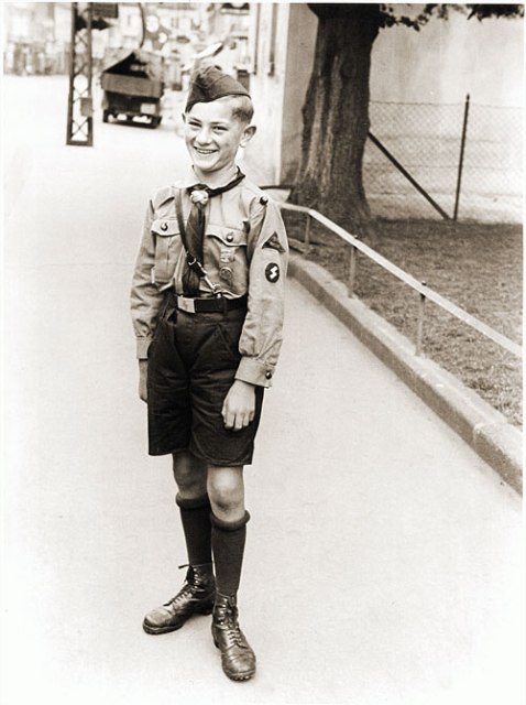 A Hitler Youth poses for a photograph in the Rhineland city of Bruehl, 1934. In 1939, membership in Nazi youth groups became mandatory for all boys and girls between the ages of ten and eighteen.