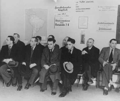 German Jews, seeking to emigrate, wait in the office of the Hilfsverein der Deutschen Juden (Relief Organization of German Jews). On the wall is a map of South America and a sign about emigration to Palestine. Berlin, Germany, 1935.