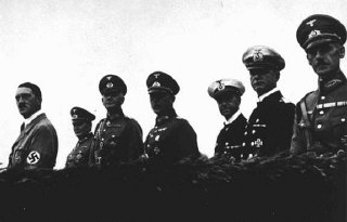 Adolf Hitler stands with his military high command...