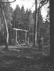 SS officers supervise the erection of a gallows, for...