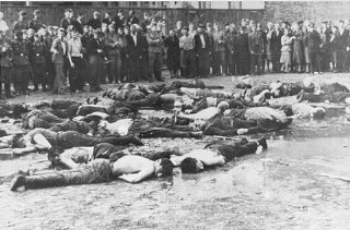 Crowd views the aftermath of a massacre at Lietukis...