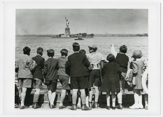 Children aboard the President Harding look at the Statue...