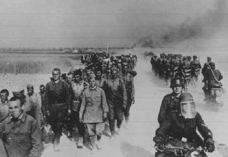 Колонна советских военнопленных (слева), которых немцы...