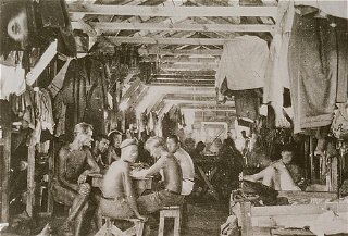 Crowded living conditions: prisoners inside a barracks...