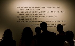Visitors stand in front of the quotation from Martin...