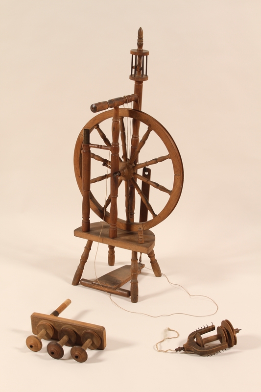 Two antique wooden spinning wheels, also called knitting yarn