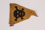 Yellow warning skull and crossbones pennant found by a concentration camp inmate after liberation