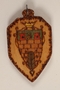 Small colored wooden pendant with the Terezin crest made by a former Jewish Czech concentration camp inmate