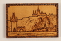 Small wooden ornament with a view of a hillside town made by a former Jewish Czech concentration camp inmate