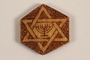 Small hexagonal, wooden tile with a Star of David and menorah made by a former Jewish Czech inmate