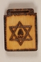 Small wooden tile with a Star of David and a cracked eggshell made by a former Jewish Czech concentration camp inmate