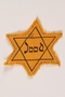 Factory-printed Star of David badge printed with Jood, belonging to a German Jewish refugee