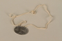 Identification tag with name and birthdate issued to a Jewish refugee child