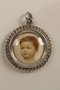 Silver locket with an engraved monogram and an infant's photo saved by an Austrian refugee family