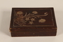 Wooden box with carved floral decorations used by a hidden child