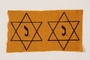 Two unused Star of David badges with a J issued to a Jewish family