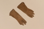 Pair of woman's fawn and tan suede gloves brought to the US by a Jewish family fleeing German occupied Poland
