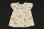Child's colorful print cotton dress with blue piping brought to the US by a Jewish family fleeing German occupied Poland
