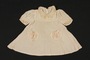 Child's peach silk polka dot dress brought to the US by a Jewish family fleeing German occupied Poland