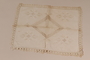 Table covering with elaborate whitework embroidery and a crocheted border recovered by Kato Ritter from her neighbors