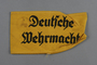 Yellow cloth armband printed Deutsche Wehrmacht