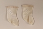 Pair of white infant socks used postwar by a former hidden child