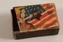 Japanese propaganda matchbox with a Japanese sword piercing the US flag acquired postwar by a German Jewish refugee