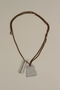 Mezuzah and tombstone pendants on a necklace made by a former concentration camp inmate in a DP camp