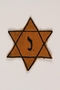 Yellow Star of David badge with the letter J worn by a Belgian Jewish boy