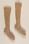 Pair of tan and white wool knit knee high socks brought to the US by a German Jewish refugee