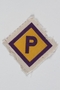 Forced labor badge, yellow with a purple P, to identify a Polish forced laborer