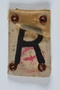 Badge with an R for Rustung (Armament) worn by a Polish Jewish worker in Beskiden labor camp