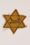 Yellow cloth Star of David badge printed with Jood, Dutch for Jew, worn by a German Jewish refugee