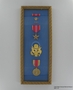 Framed set of military medals, ribbons, and insignia awarded to US Army Captain J.G. Mitnick