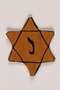 Yellow cloth Star of David badge with the letter J. to identify a Belgian Jew