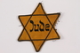 Star of David badge printed Jude worn by a Jewish prisoner in Terezin