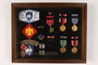Shadow box containing mounted military medals and insignia of a US Army Captain